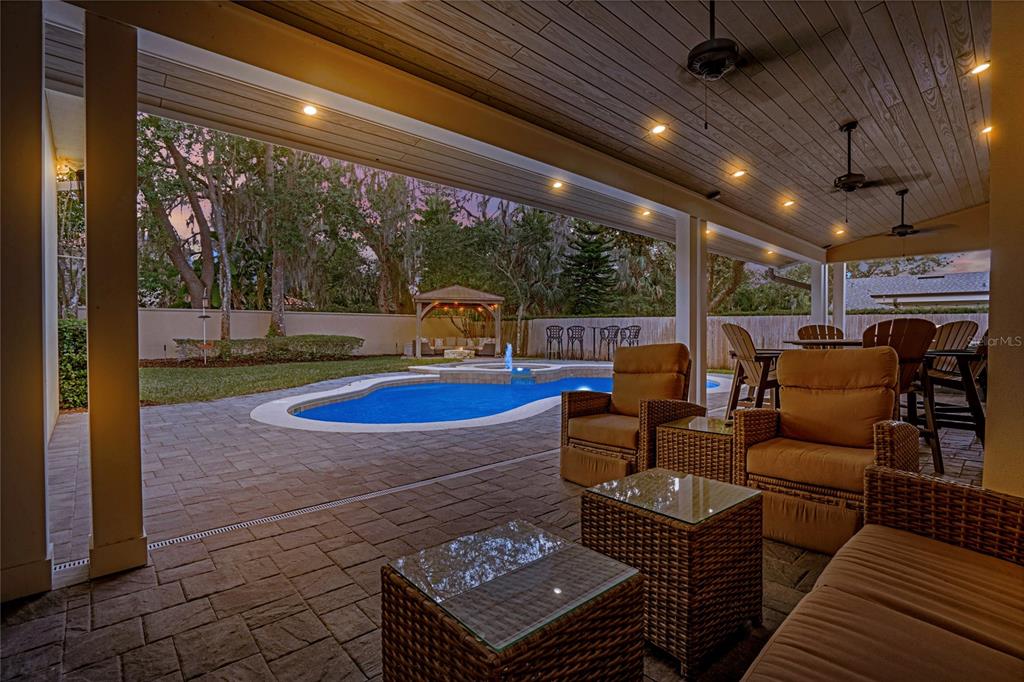 A two-story house with a columned front porch and balcony stands behind a brick walkway — 450 LAKEWOOD DRIVE, WINTER PARK, FL