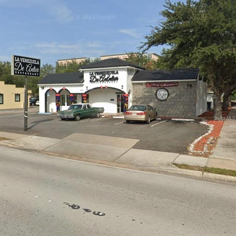 A single-story restaurant building with a parking lot and a prominent sign in front — 507 W VINE STREET, KISSIMMEE, FL
