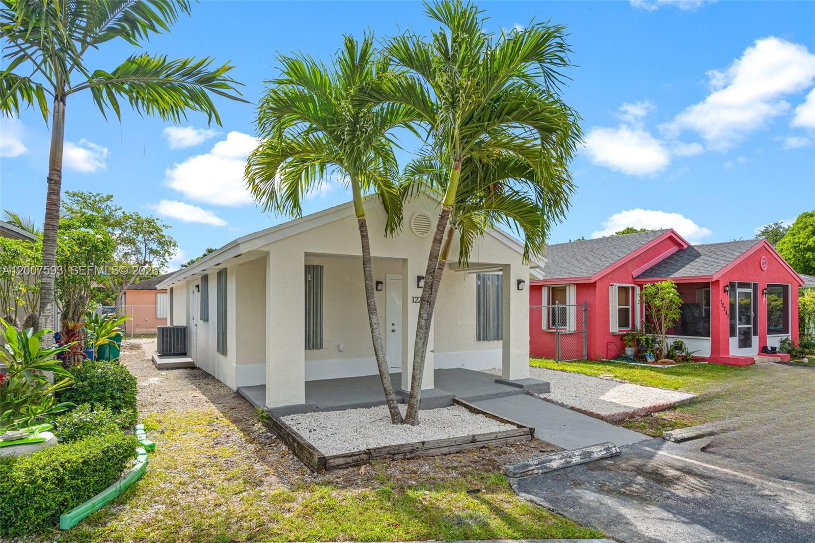 A single-story house with a white exterior and a palm tree in the front yard — 12245 SW 201st Ter, Miami FL 33177, MIAMI, FL
