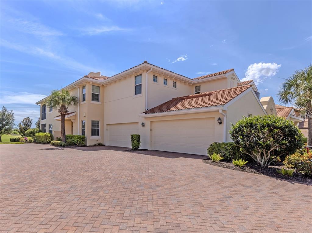 A two-story stucco house with a tile roof and a large brick paver driveway — 194 BELLA VISTA TERRACE UNIT 26A, NORTH VENICE, FL