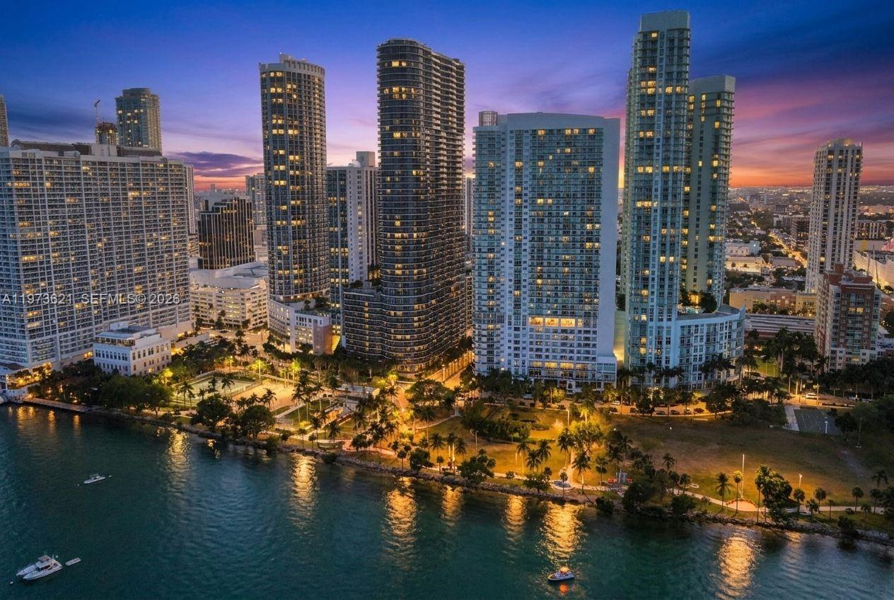 An aerial view of a waterfront city skyline with high-rise buildings at dusk — 1750 N Bayshore Dr # 2510, Miami FL 33132, MIAMI, FL