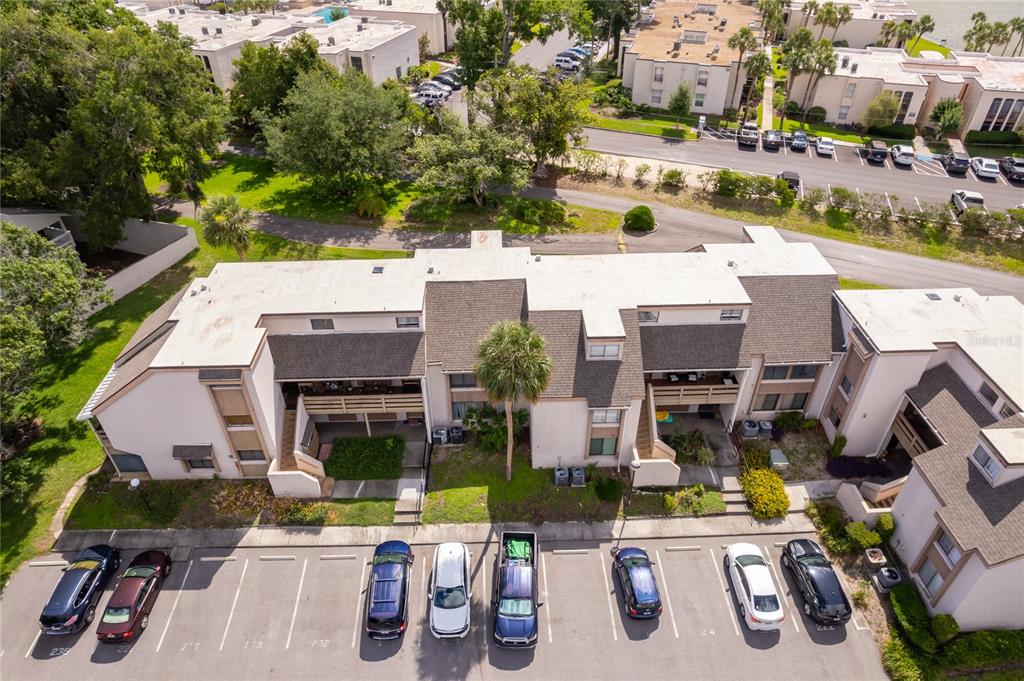 An aerial view shows a multi-story apartment building with a parking lot in front — 228 ORIENTA POINT STREET UNIT 228, ALTAMONTE SPRINGS, FL