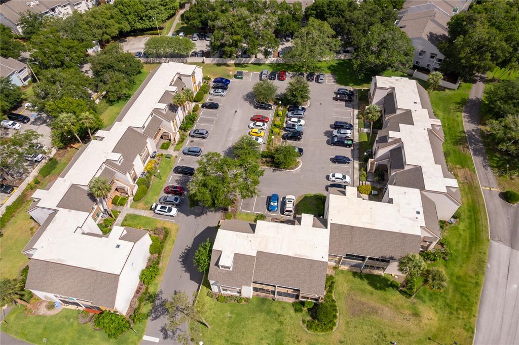 An aerial view shows multi-unit residential buildings surrounding a central parking lot with many cars — 228 ORIENTA POINT STREET UNIT 228, ALTAMONTE SPRINGS, FL