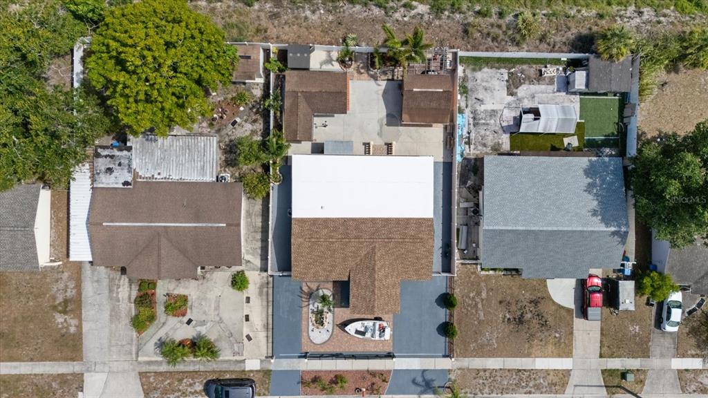 An aerial view shows three residential properties with driveways, roofs, and backyard structures — 8318 DRYCREEK DRIVE, TAMPA, FL