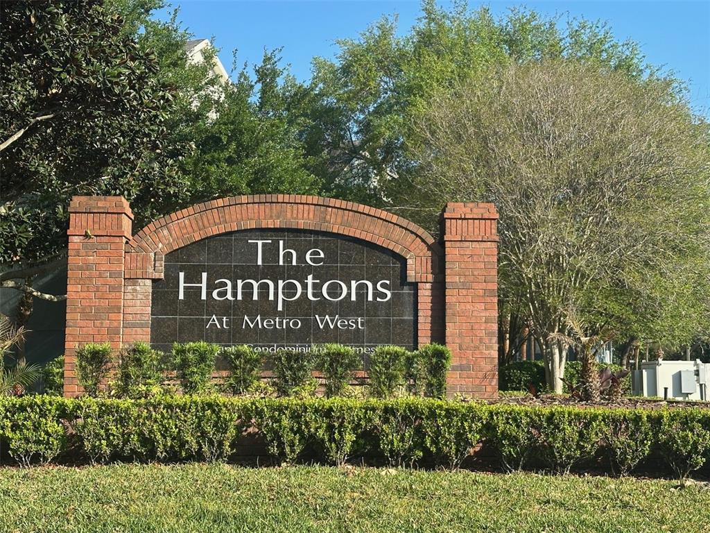 A concrete path leads toward a lake surrounded by trees and aquatic vegetation — 3250 CORONA VILLAGE WAY UNIT 206, ORLANDO, FL