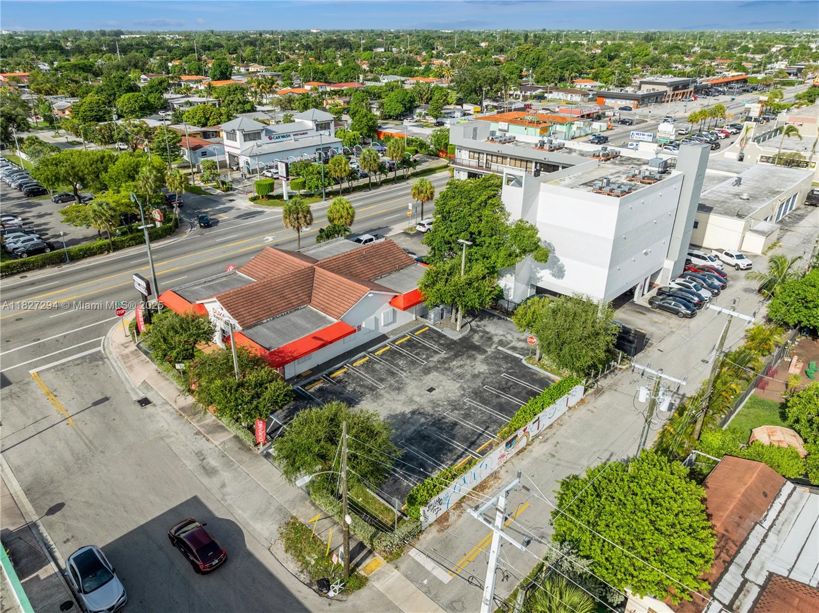 An aerial view shows a commercial building with a parking lot and surrounding streets — 7101 SW 8th St, Miami FL 33144, MIAMI, FL