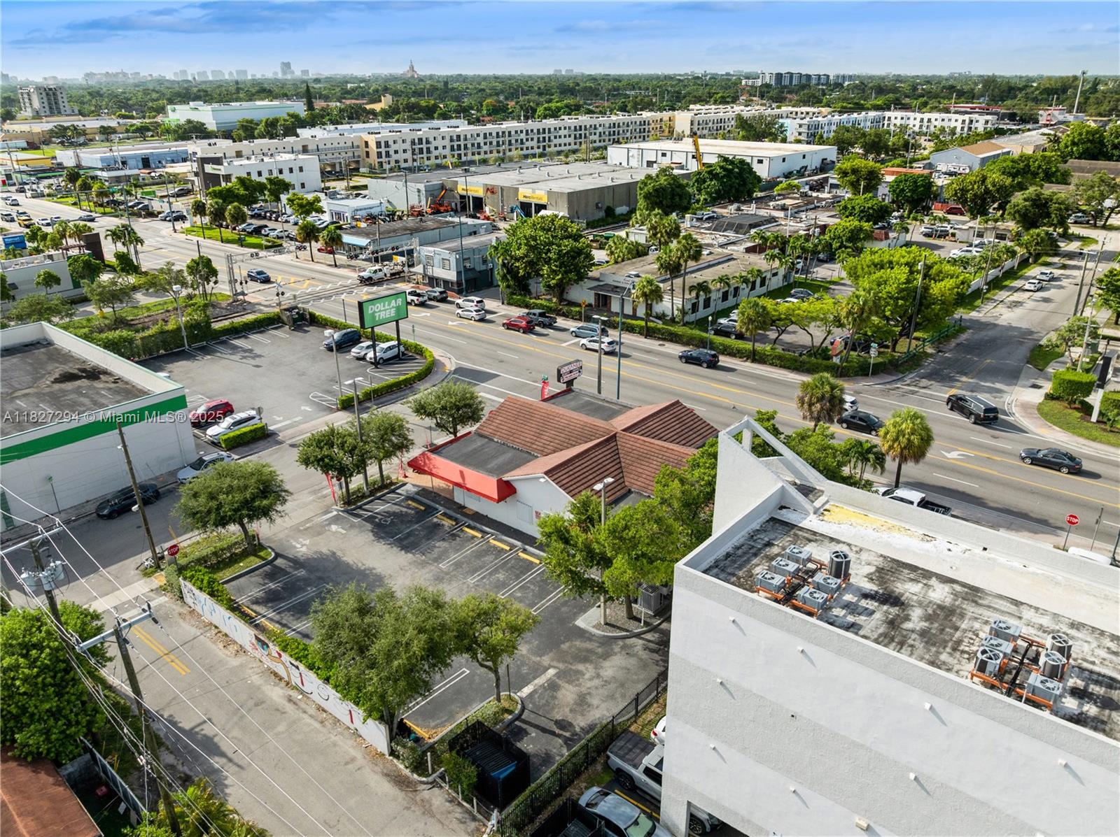 An aerial view shows a commercial building with a parking lot and surrounding urban streets — 7101 SW 8th St, Miami FL 33144, MIAMI, FL