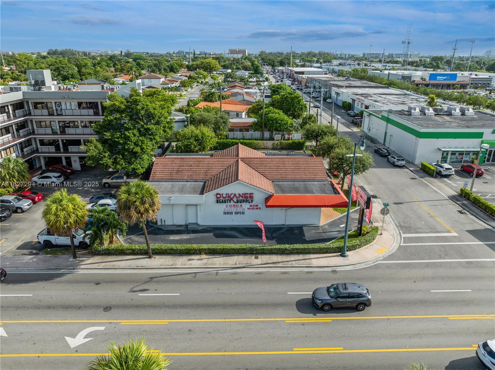An aerial view shows a commercial building with a red tile roof and parking lot — 7101 SW 8th St, Miami FL 33144, MIAMI, FL
