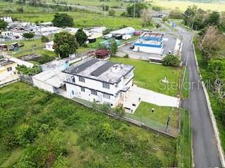An aerial view shows a two-story white house with a flat roof and surrounding yard — 927 ANTON RUIZ UNIT KM 27.7, HUMACAO, PR