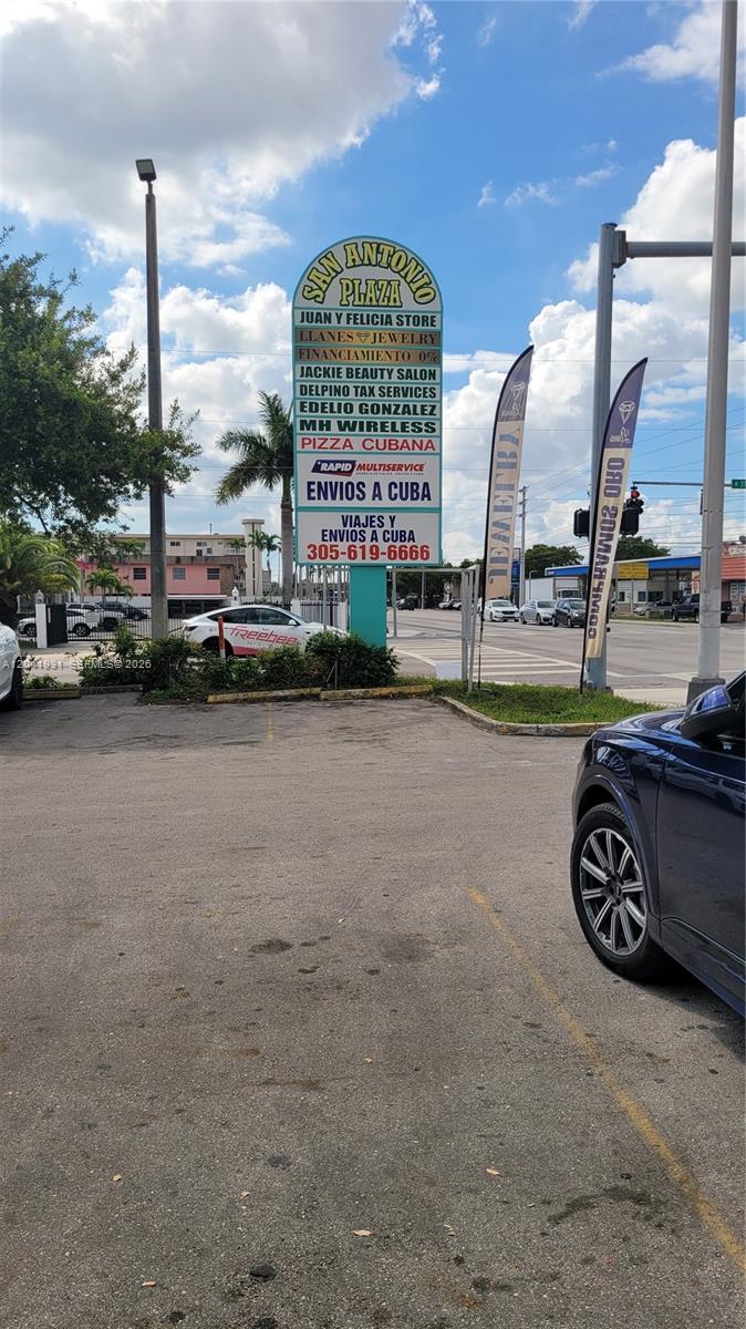 A parking lot faces a tall sign listing various businesses at San Antonio Plaza — 1169 W 37th St # 1181, Hialeah FL 33012, HIALEAH, FL