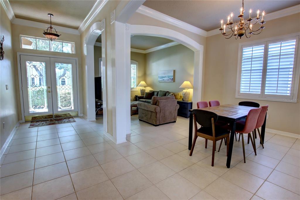 A dining area and living room are visible from an entryway with tiled floors — 1467 CHESSINGTON CIRCLE, LAKE MARY, FL