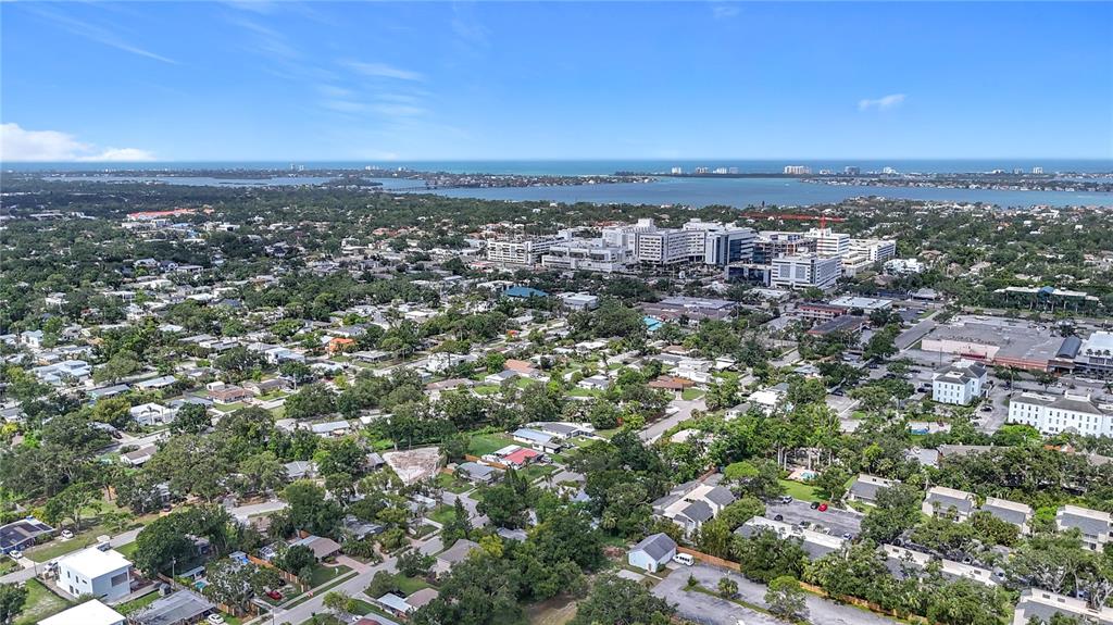 An aerial view shows a residential neighborhood with a large hospital complex in the distance — 2220 BAHIA VISTA STREET UNIT G5, SARASOTA, FL