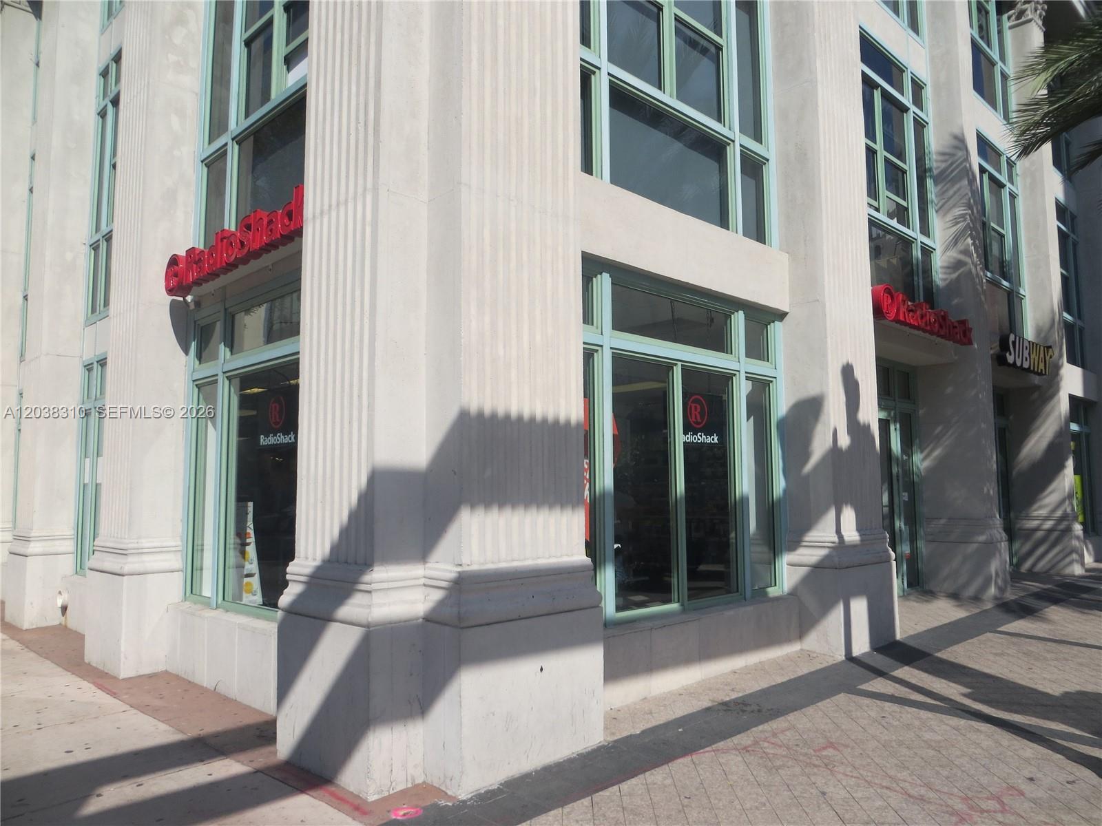 A corner view of a commercial building exterior featuring RadioShack signage and a Subway sign — 111 E Flagler St # 503, Miami FL 33131, MIAMI, FL