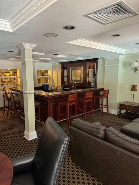 A room features a wooden bar with stools, recessed lighting, and a leather sofa — 1919 Van Buren St # 516A, Hollywood FL 33020, HOLLYWOOD, FL