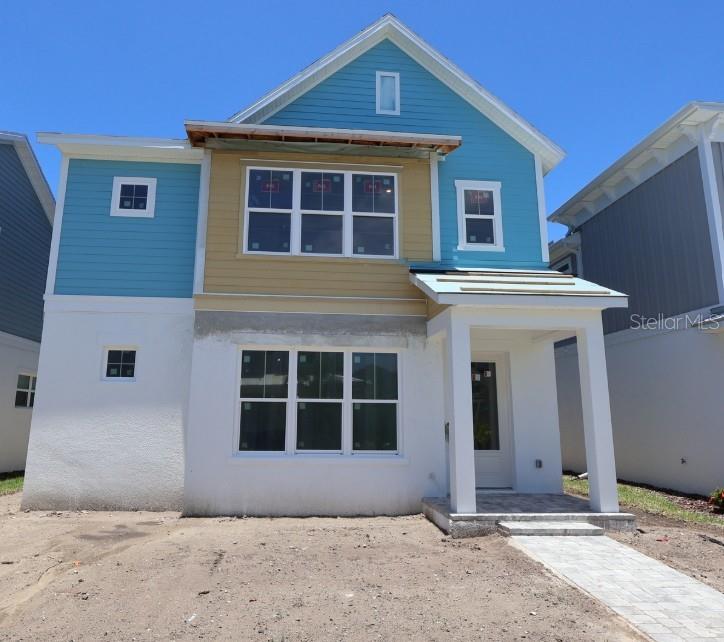 A two-story house under construction features blue and tan siding, white stucco, and a porch — 7271 KODIAK LANE, SARASOTA, FL