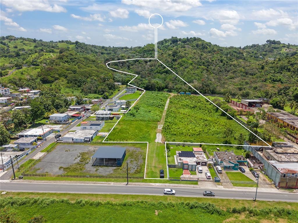 An aerial view shows a large, irregularly shaped vacant lot outlined in white near houses — PR 182 KM 3.3 BO. CALABAZAS, YABUCOA, PR