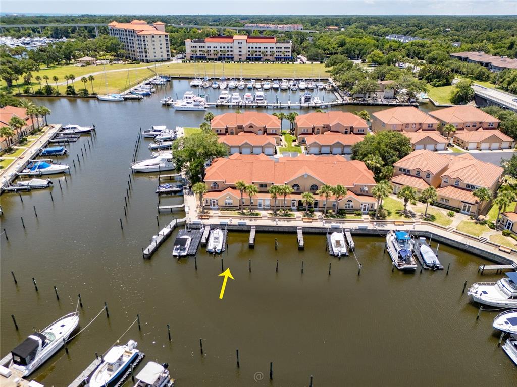An aerial view shows a waterfront residential complex with a boat dock and marina — 49B MARINA POINT PLACE UNIT SLIP  49B, PALM COAST, FL
