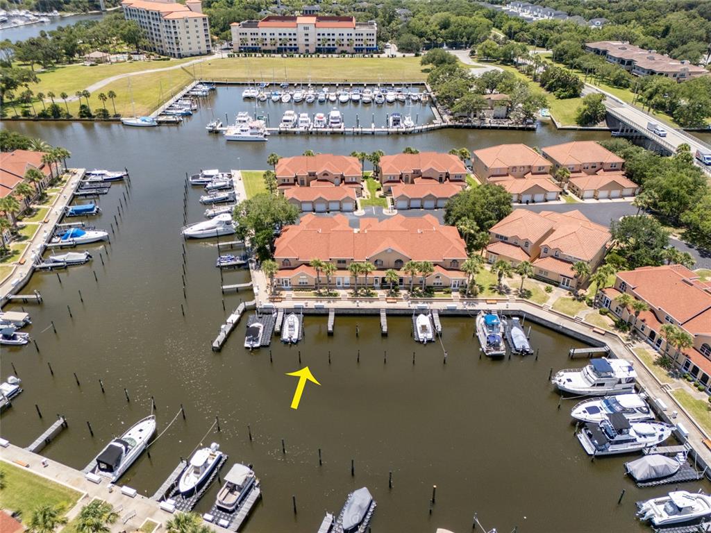 An aerial view shows a residential complex with a marina and multiple docked boats — 49B MARINA POINT PLACE UNIT SLIP  49B, PALM COAST, FL