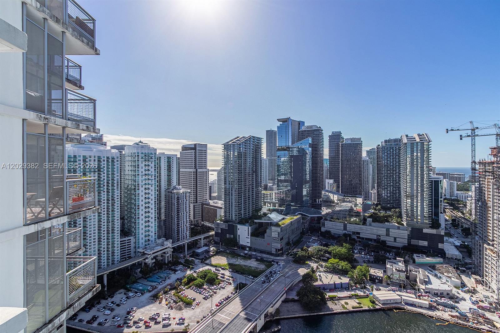 A high-angle view of a dense urban skyline with skyscrapers, a highway, and a parking lot — 350 S Miami Ave # 3914, Miami FL 33130, MIAMI, FL