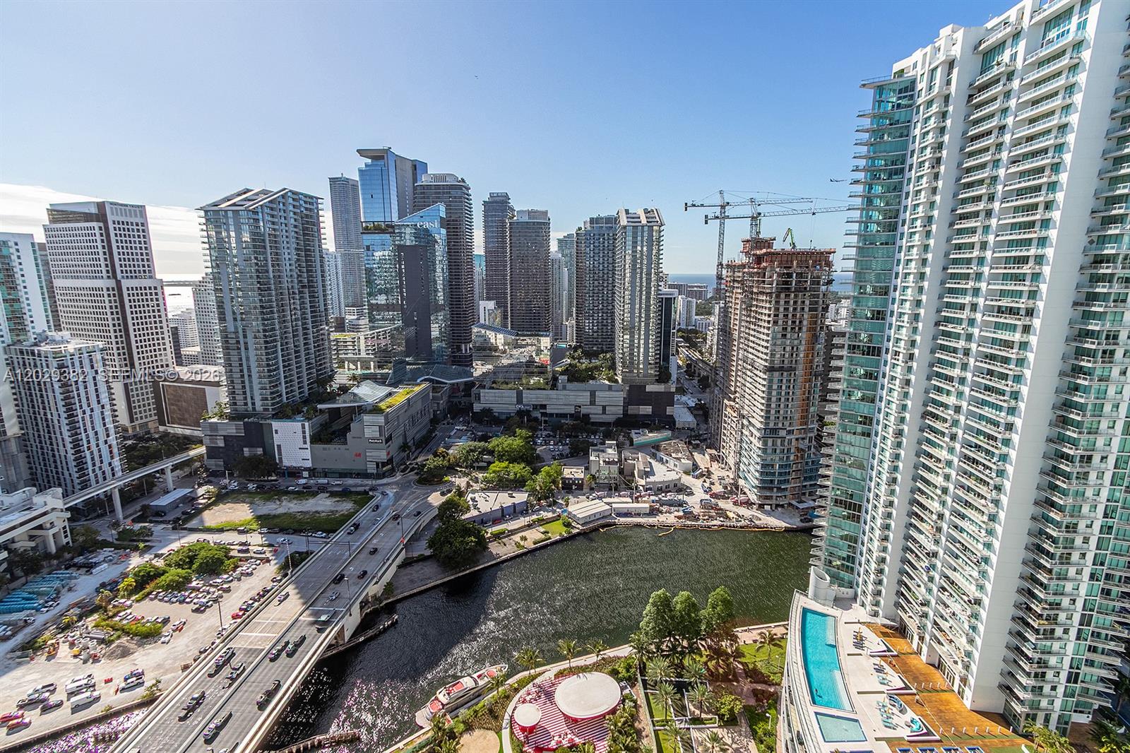 An elevated view of a city skyline featuring skyscrapers, a river, and a bridge — 350 S Miami Ave # 3914, Miami FL 33130, MIAMI, FL