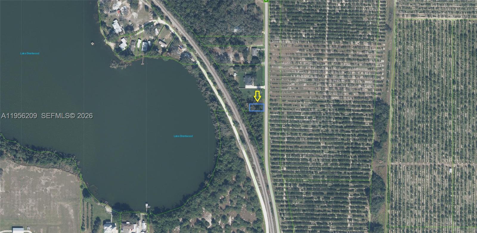 This is an aerial map showing a vacant lot highlighted by a yellow arrow — 1701 N GASTER RD, Avon Park FL 33825, AVON PARK, FL