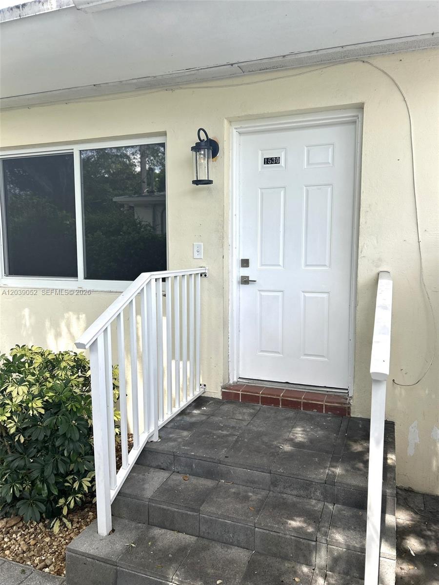A white front door with the number 1530 sits at the top of stone steps — 1530 NE 110th Ter, Miami FL 33161, MIAMI, FL
