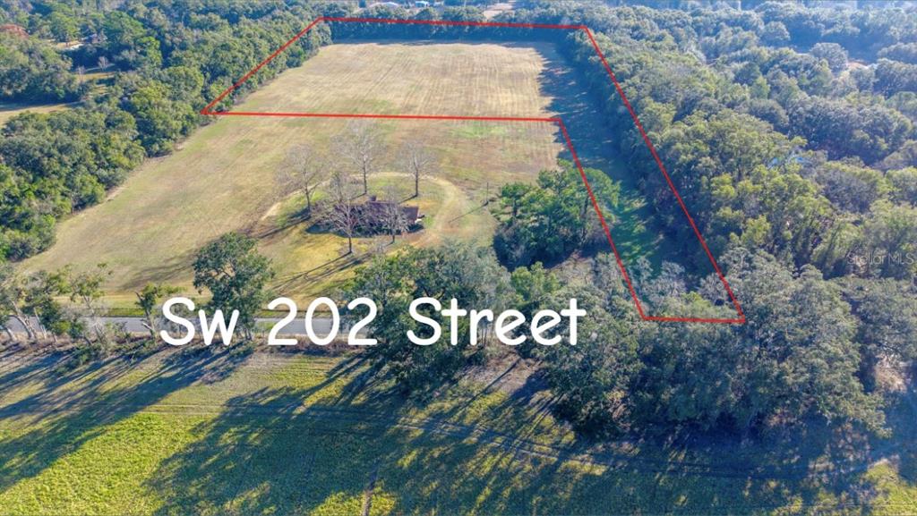 An aerial view shows a house surrounded by trees on a large, partially cleared lot — 0000 SW 202 STREET, NEWBERRY, FL
