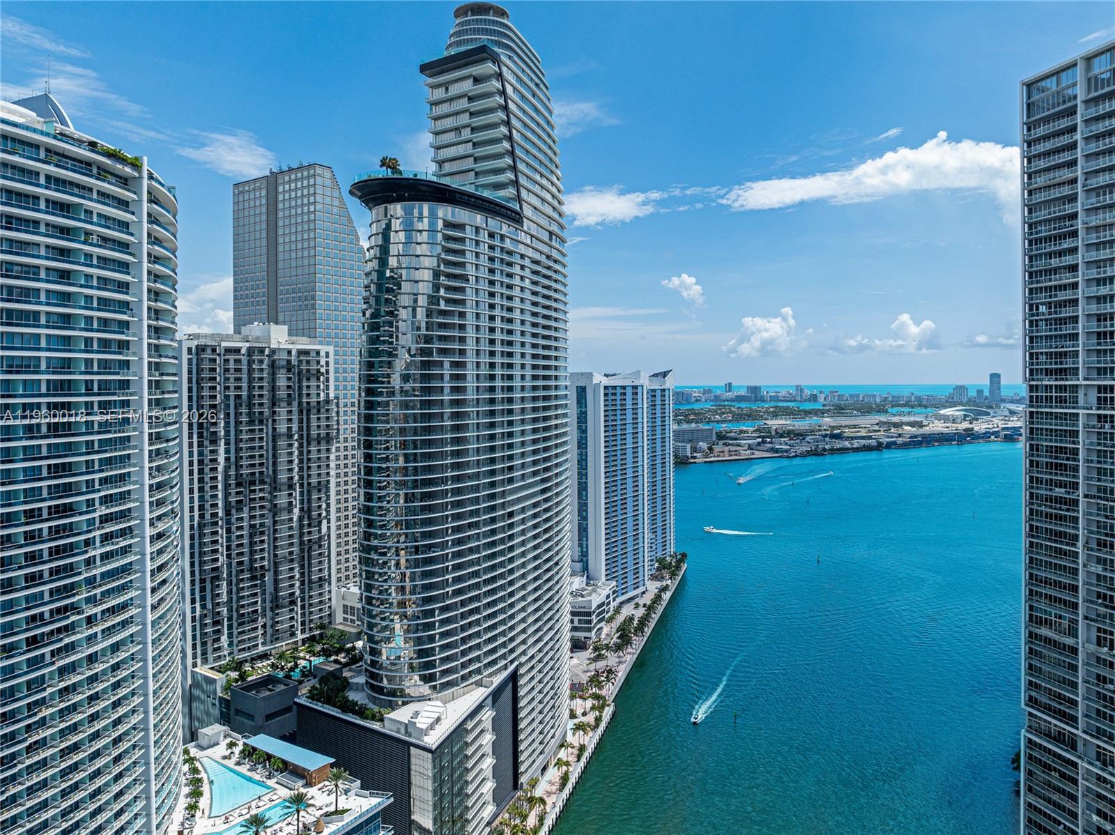 An aerial view of modern high-rise residential towers along a waterfront in Miami — 300 BISCAYNE BLVD WAY # 2009, Miami FL 33131, MIAMI, FL