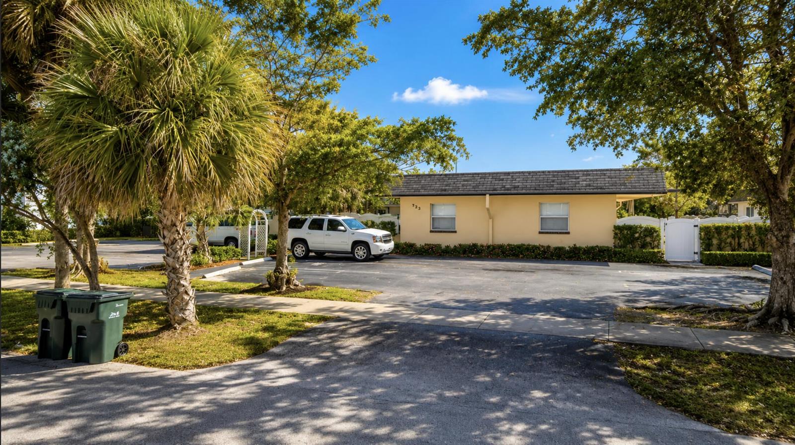 A yellow single-story building with a parking lot and trees in front — 211 S Swinton Avenue, Delray Beach FL 33444, DELRAY BEACH, FL