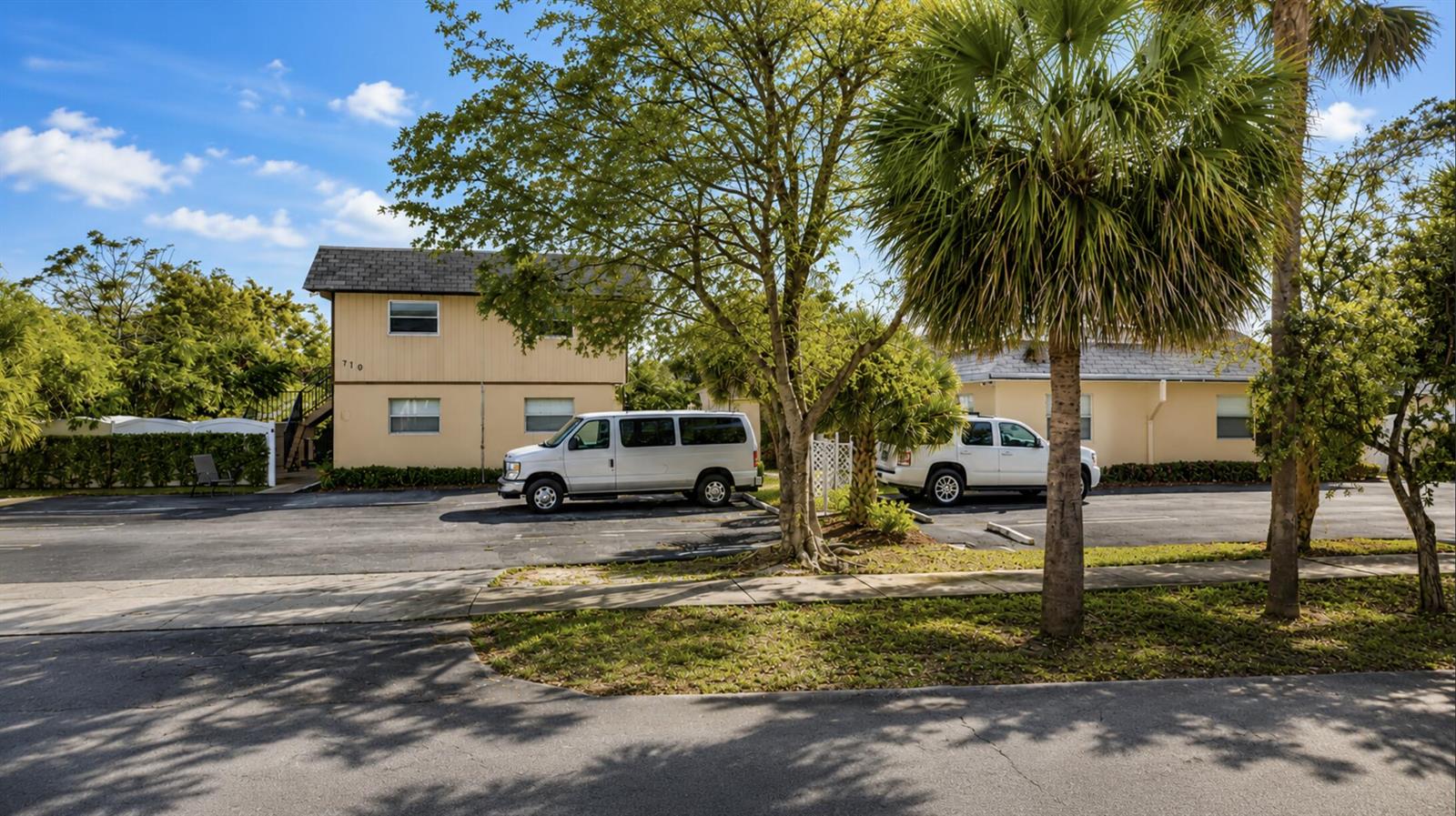 A two-story apartment building with a parking lot and two white vans in front — 211 S Swinton Avenue, Delray Beach FL 33444, DELRAY BEACH, FL