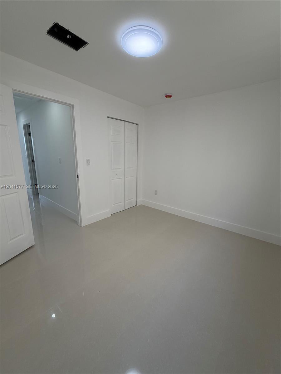 This room features white walls, light-colored tile flooring, a ceiling light, and a closet — 1551 W Okeechobee Rd # 3, Hialeah FL 33010, HIALEAH, FL