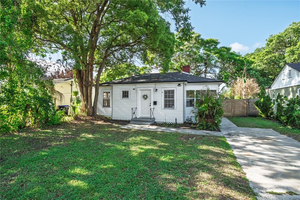 A white single-story house with a front lawn, driveway, and large trees — 2006 CORNELL AVENUE, WINTER PARK, FL