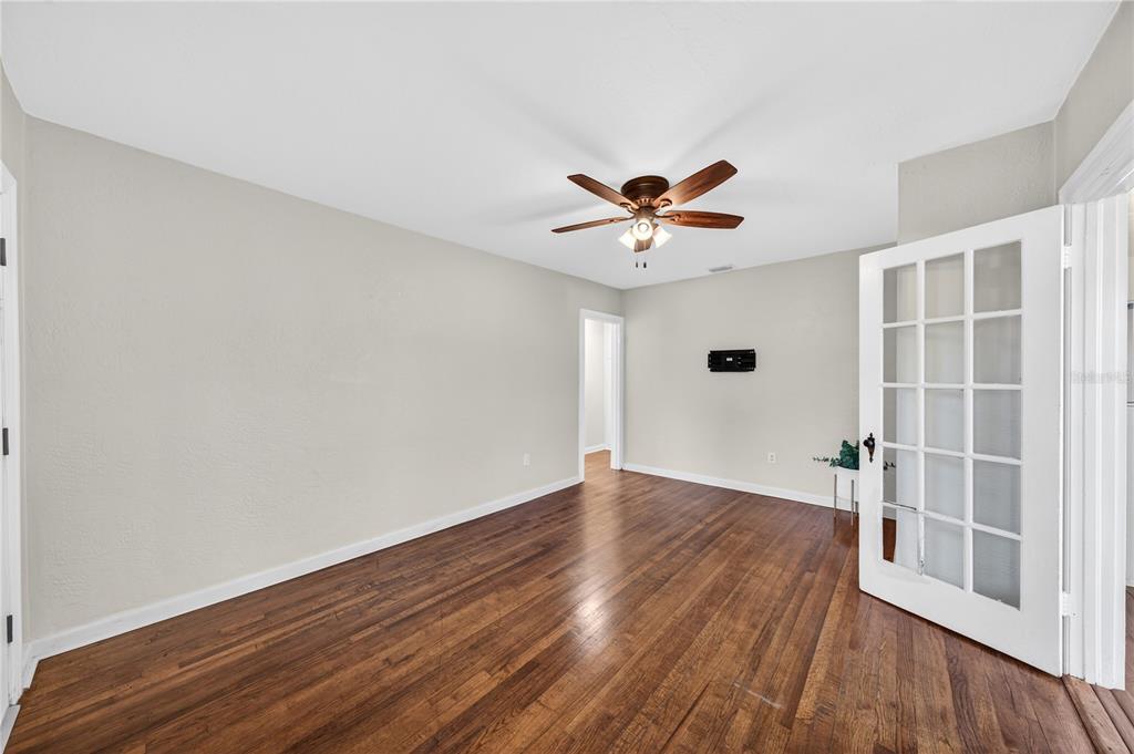An empty room with hardwood floors, white walls, a ceiling fan, and French doors — 2006 CORNELL AVENUE, WINTER PARK, FL