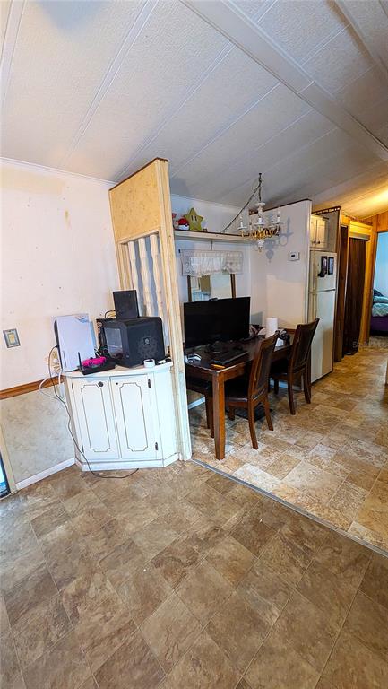 A dining area features a wooden table, chairs, a corner cabinet, and tiled flooring — 3000 CLARCONA ROAD UNIT 520, APOPKA, FL