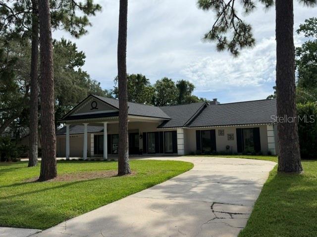 A single-story house with a covered front porch and columns at dusk — 210 W TIMBERCOVE CIRCLE, LONGWOOD, FL