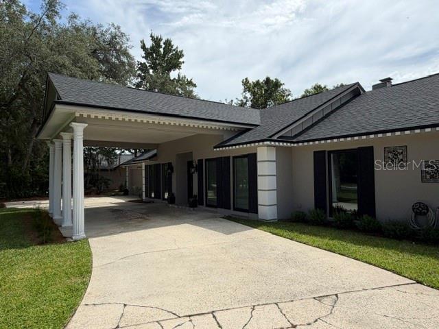 A single-story house with a large covered porch and white columns at night — 210 W TIMBERCOVE CIRCLE, LONGWOOD, FL
