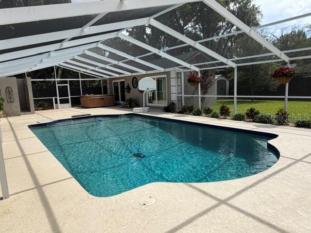 A single-story house with a covered porte-cochère and a stone driveway at night — 210 W TIMBERCOVE CIRCLE, LONGWOOD, FL
