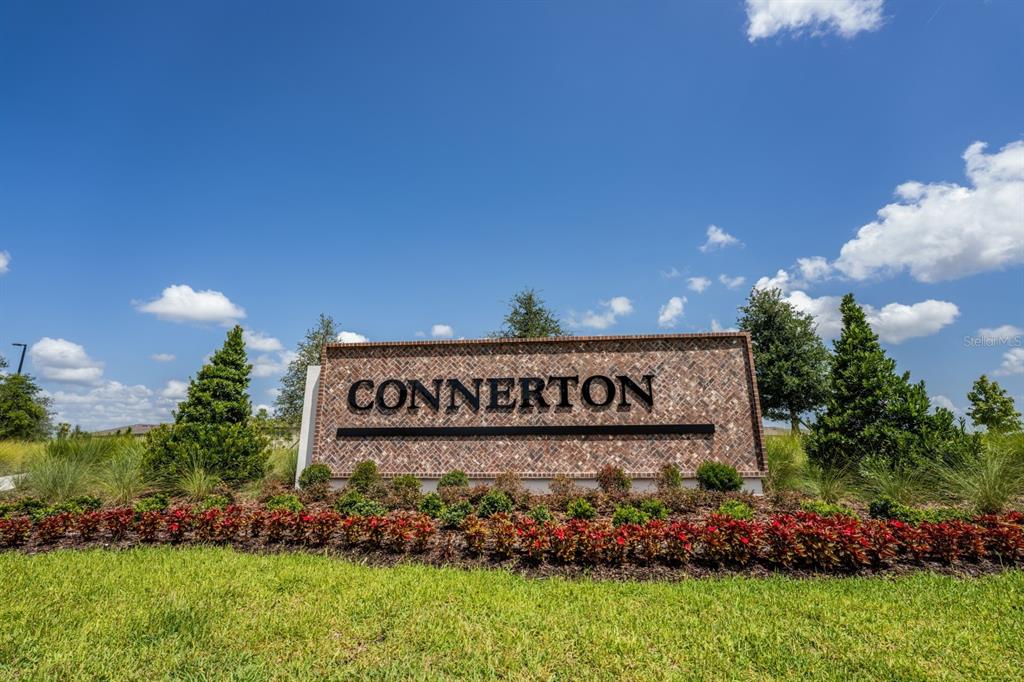 A brick monument sign with the name Connerton stands in a landscaped garden — 22430 BLAZING STAR, LAND O LAKES, FL