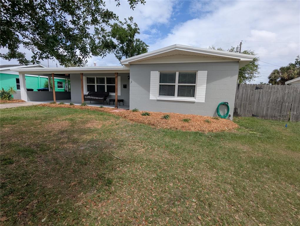 A single-story gray house features a covered porch, white shutters, and a front lawn — 5421 ALLOWAY STREET, ORLANDO, FL