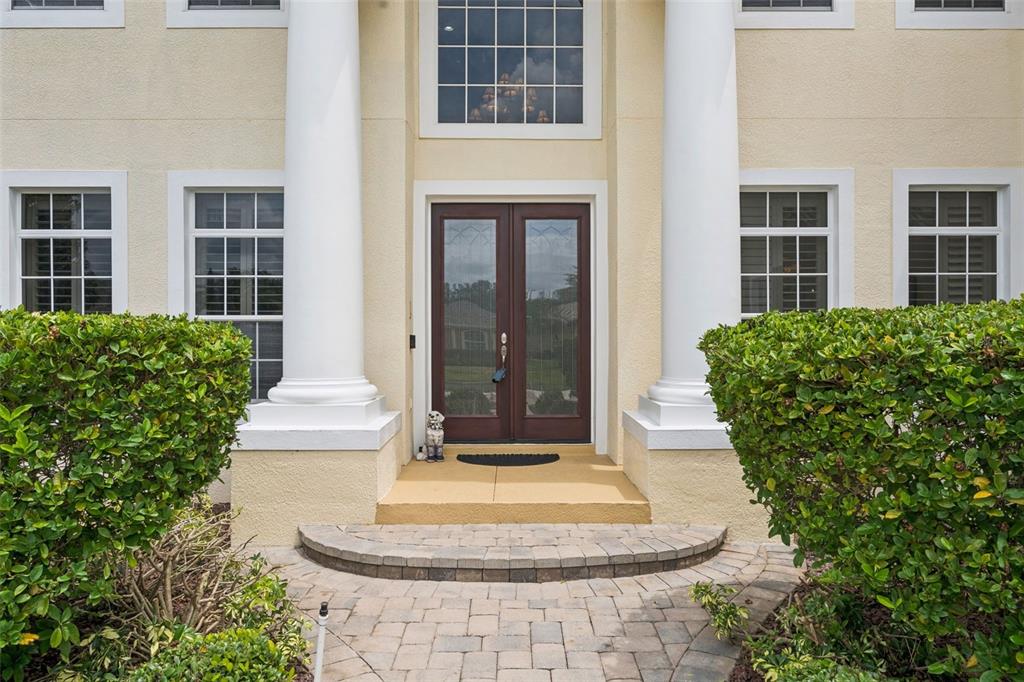 A front entrance features a double door, white columns, and a stone walkway — 1692 ORANGE THORPE LANE, CLERMONT, FL