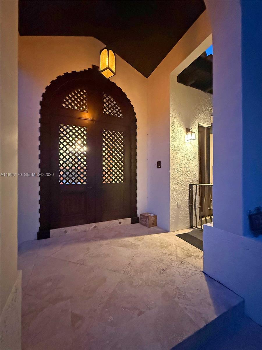 A white house features a brick driveway leading to a covered carport and garage — 1253 Sorolla Ave, Coral Gables FL 33134, CORAL GABLES, FL