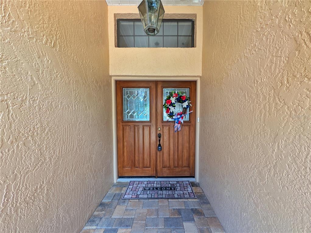 A front entryway features double wooden doors with glass panels and a stone-tiled floor — 4023 N RINGWOOD CIRCLE, HERNANDO, FL