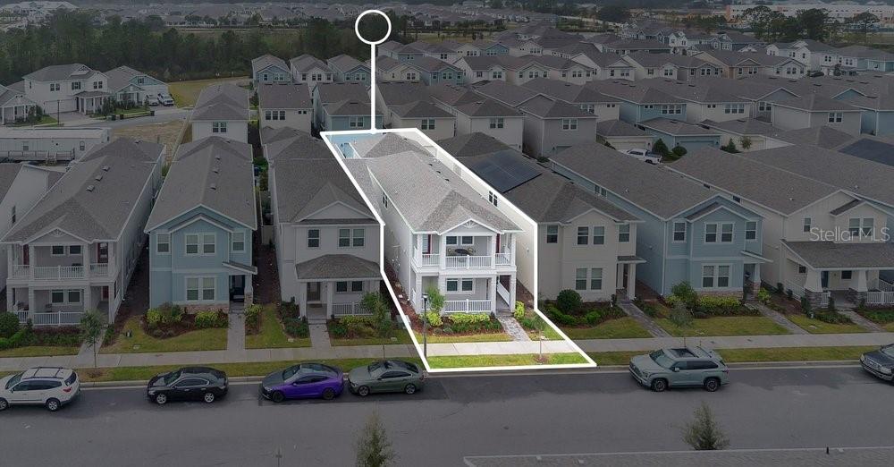 An aerial view shows a two-story house with a white porch and balcony — 15026 SUMMER HARVEST STREET, WINTER GARDEN, FL