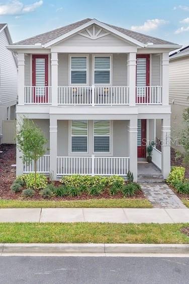 A two-story house with a gray exterior, white railings, and red doors on both levels — 15026 SUMMER HARVEST STREET, WINTER GARDEN, FL