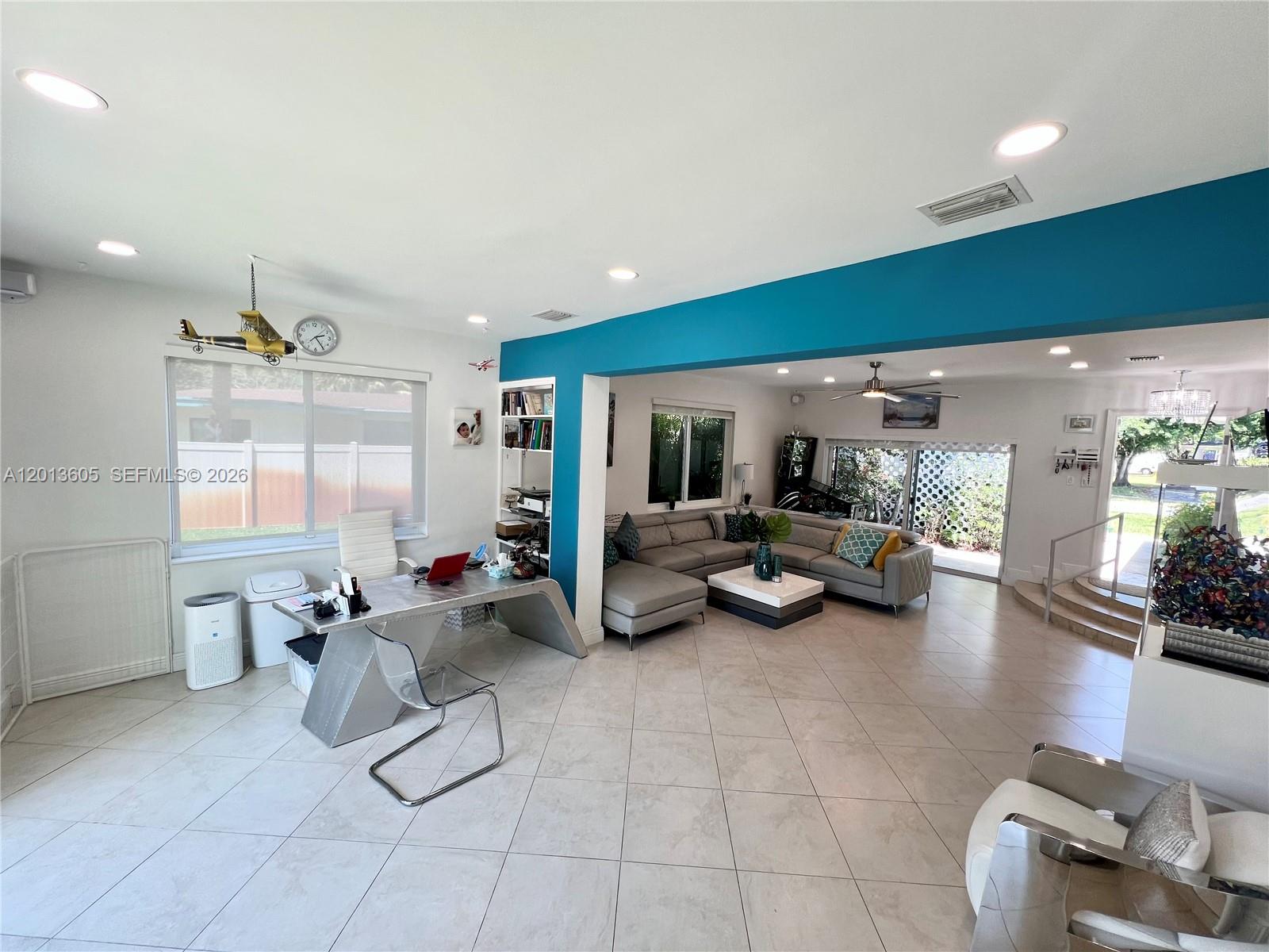 An open-concept living area features a home office, a sectional sofa, and tiled floors — 101 SW 58th Ave # 101, Plantation FL 33317, PLANTATION, FL
