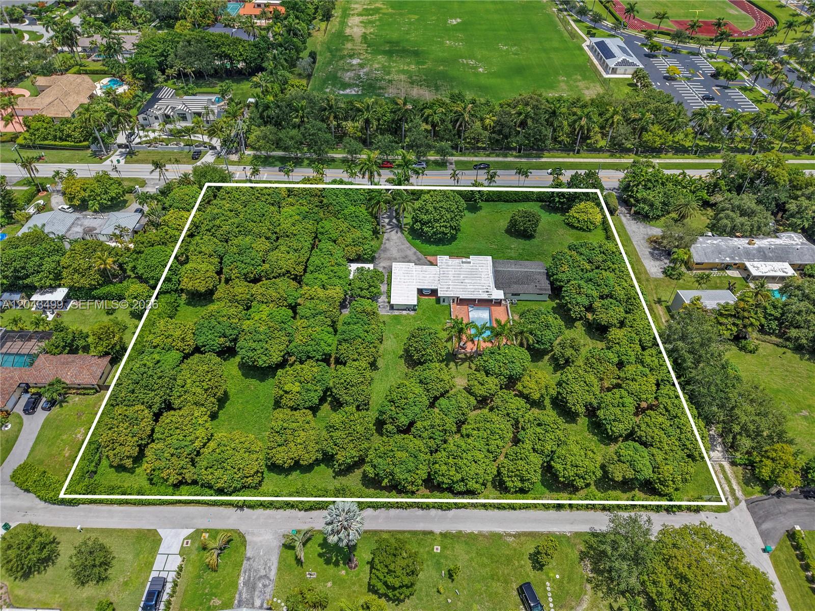 An aerial view shows a house with a pool surrounded by dense trees and lawns — 8000 SW 184th St, Cutler Bay FL 33157, CUTLER BAY, FL