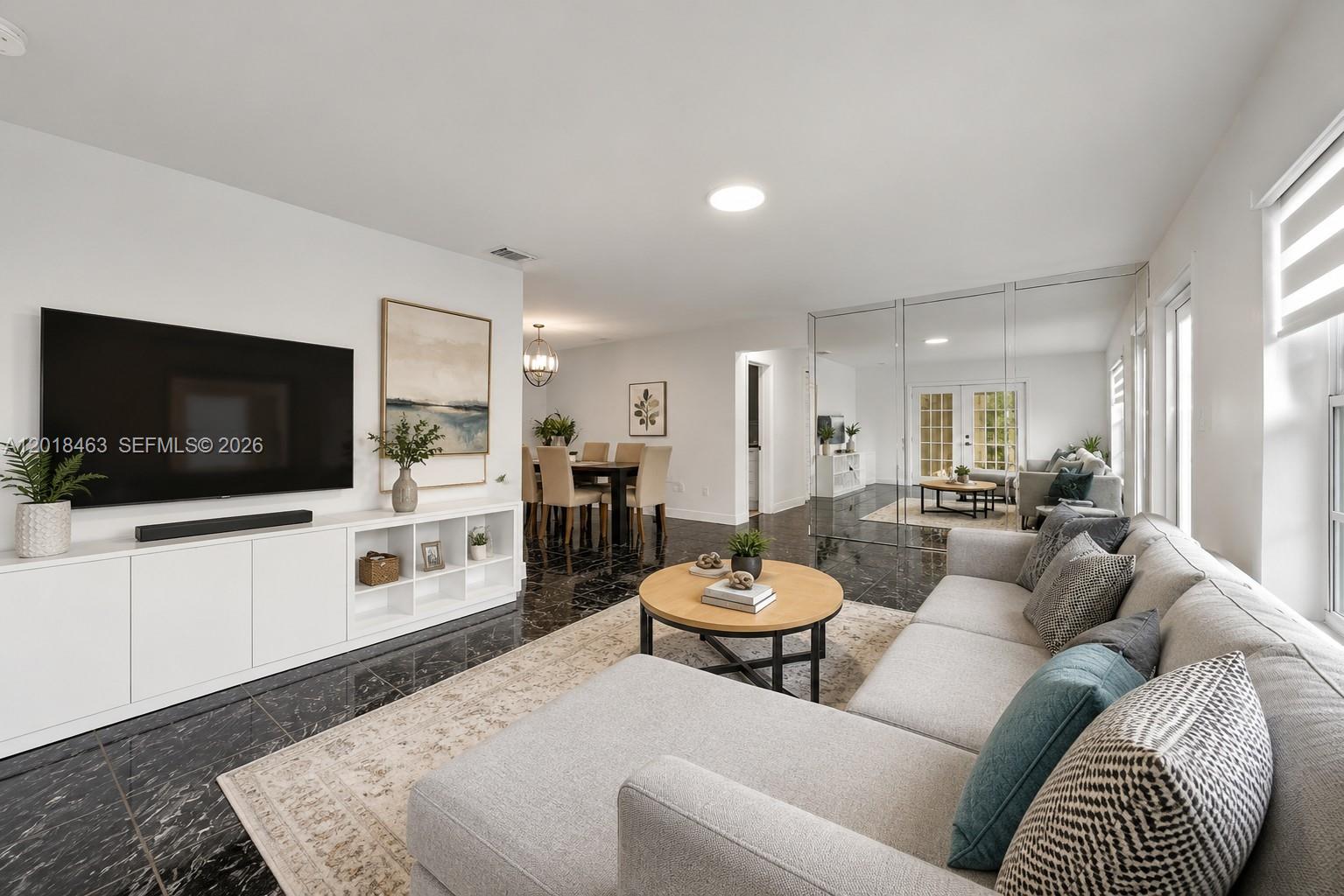 A living room features black marble floors, a white media console, and a sectional sofa — 15725 SW 102nd Pl, Miami FL 33157, MIAMI, FL