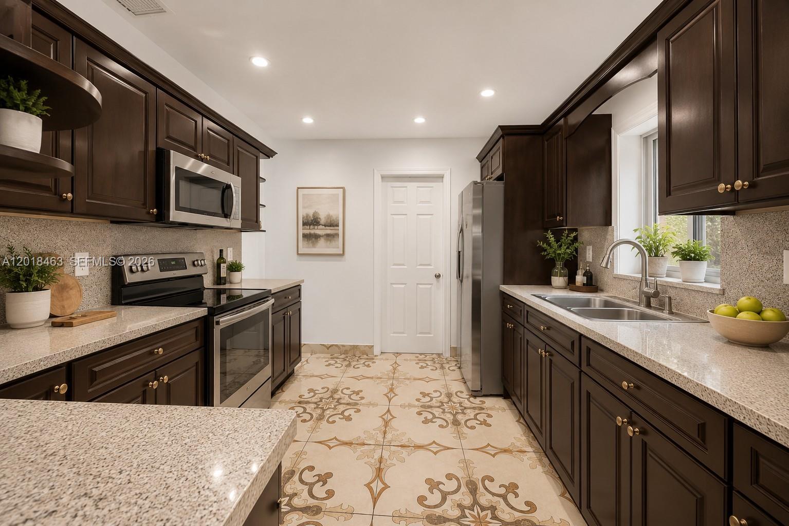 A kitchen features dark wood cabinets, granite countertops, and patterned tile flooring — 15725 SW 102nd Pl, Miami FL 33157, MIAMI, FL