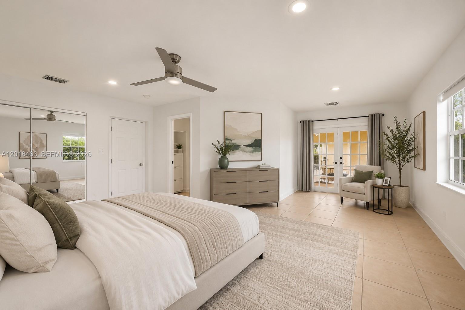 A bedroom features a bed, dresser, armchair, and glass doors leading to an outdoor area — 15725 SW 102nd Pl, Miami FL 33157, MIAMI, FL