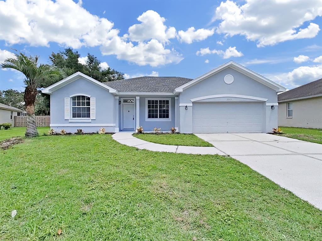 A light blue single-story house with a two-car garage and a front lawn — 3313 MICHENER PLACE, PLANT CITY, FL
